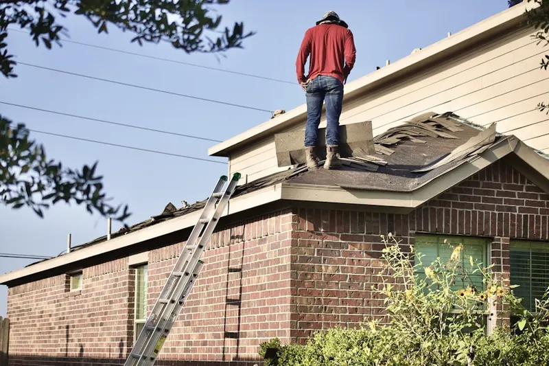 Professional roofer working on a residential roof in Palmer Ranch